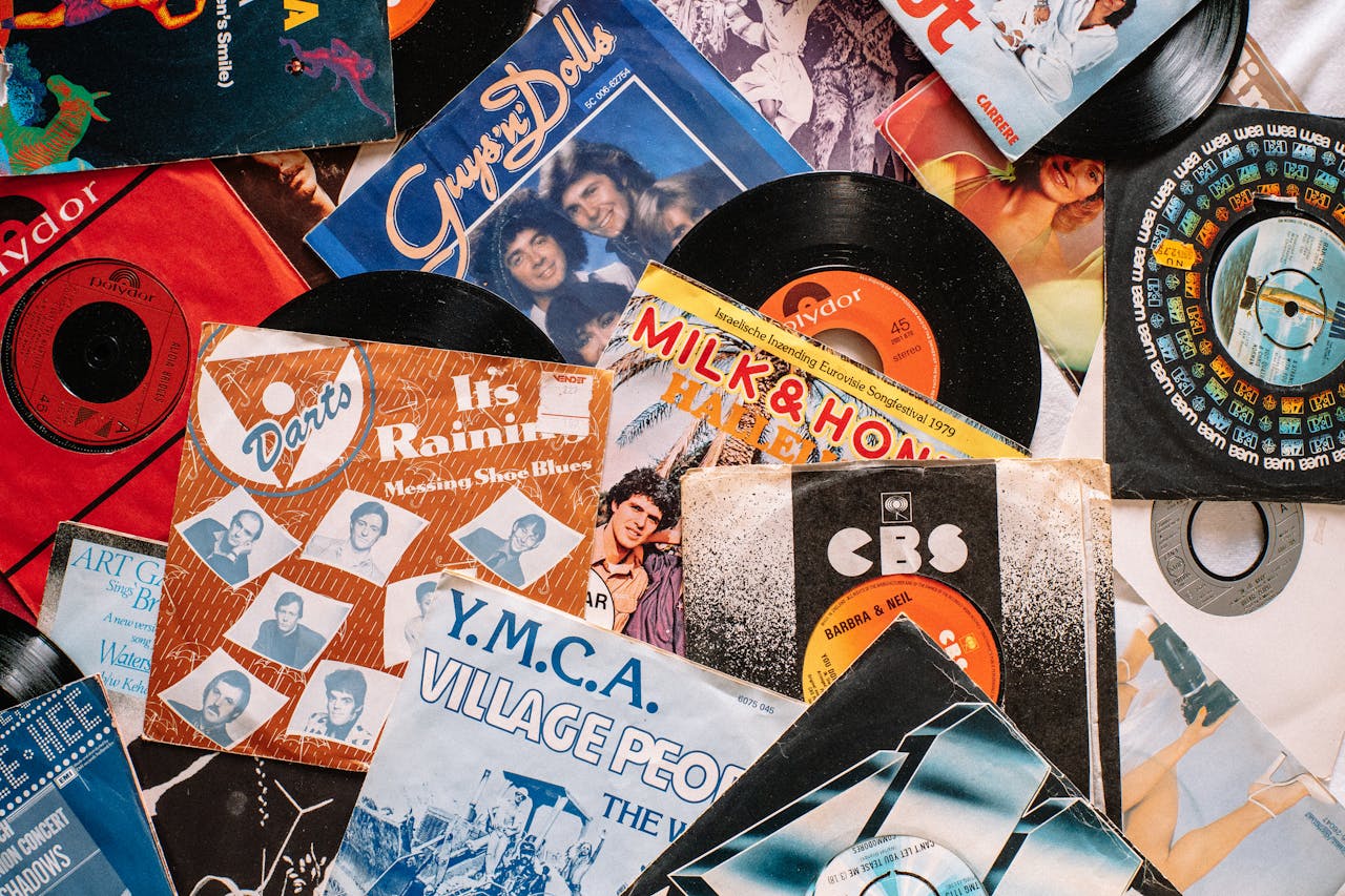 about-03 A flat lay of vintage vinyl record covers showcasing 70s and 80s music nostalgia.
